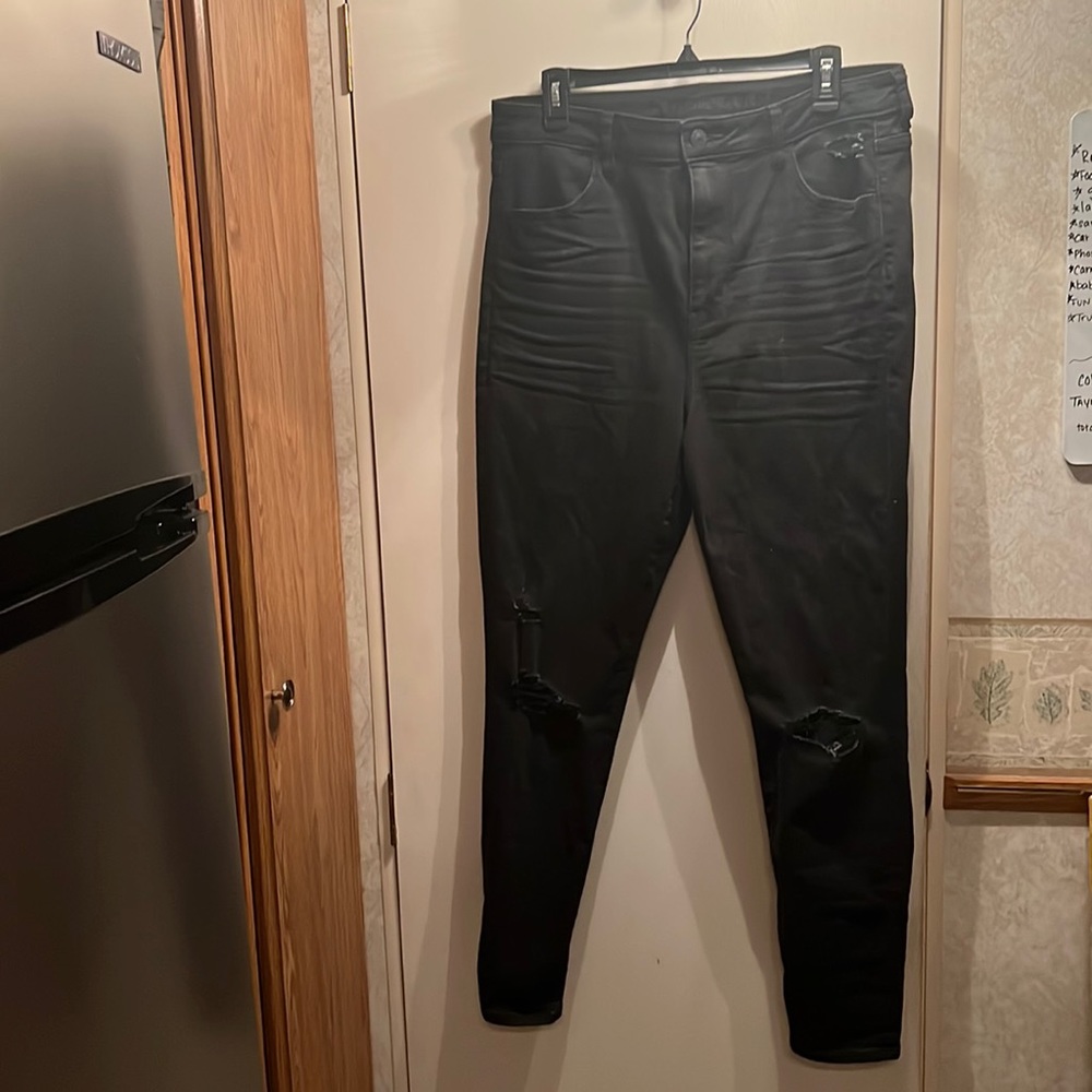 Never worn distressed knee black skinny jeans